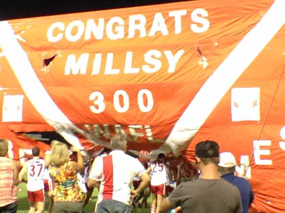 South Fremantle players burst through the banner marking Kris Miller's 300th WAFL game. Photo by Les Everett