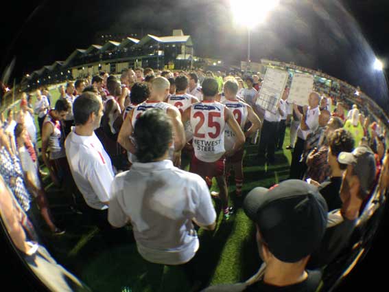 The confident Bulldog huddle at quarter time. photo by Les Everett