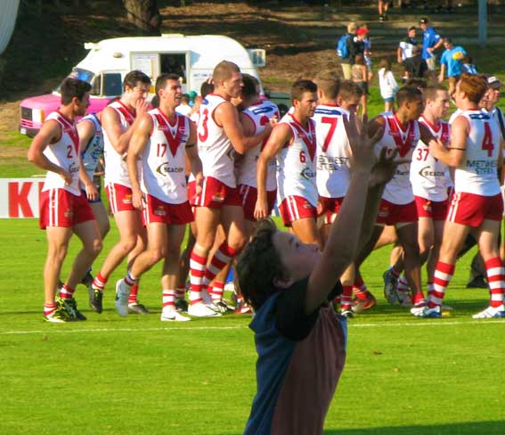 A young fan gets into his half time kick to kick while the pumped up Bulldogs head for the rooms. Photo by Les Everett.