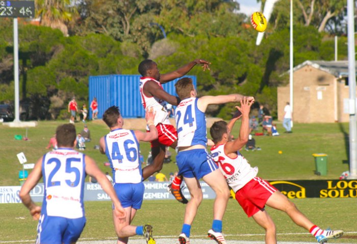 Paul Mugumbwa gets up high to spoil during the derby. Photo by Les Everett