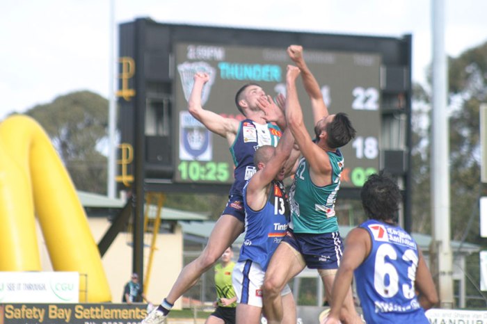 East Perth's Craig Wulff finds he's the filling in a Peel defensive sandwich. Photos by Les Everett